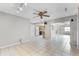 Open living area features tile flooring and access to the kitchen and other rooms at 2666 Derbyshire Rd, Maitland, FL 32751