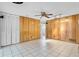 Living area featuring tile flooring, paneled wall, and closet at 2666 Derbyshire Rd, Maitland, FL 32751
