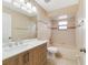Bright bathroom with modern vanity, a combination shower and tub, and a window at 2880 Trenton Ln, Deltona, FL 32738