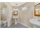 Bright bathroom with black and white tiled floors, two sinks, and ample vanity lighting at 2880 Trenton Ln, Deltona, FL 32738