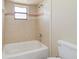 Clean bathroom with a tub and shower combo, tiled walls, and modern fixtures at 2880 Trenton Ln, Deltona, FL 32738