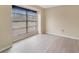 Bright bedroom with large window and blinds showcasing neutral walls and light laminate flooring at 2880 Trenton Ln, Deltona, FL 32738
