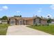 Traditional single-story home with brick accents, attached garage, and a large driveway at 2880 Trenton Ln, Deltona, FL 32738