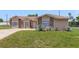 Exterior view of a home featuring a well-maintained front yard and mature plants at 2880 Trenton Ln, Deltona, FL 32738