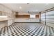Garage featuring a black and white checkered floor and lots of storage at 2880 Trenton Ln, Deltona, FL 32738