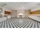 Spacious garage featuring a black and white checkered floor and lots of storage at 2880 Trenton Ln, Deltona, FL 32738