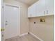 Laundry room with white cabinets and neutral colored walls at 2880 Trenton Ln, Deltona, FL 32738