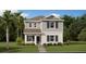 Charming two-story home with green shutters, a stone walkway, and lush landscaping on a bright, sunny day at 3009 Namaste Dr, Clermont, FL 34714