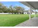 Expansive green backyard of modern home with a white privacy fence and mature shade trees at 3022 Peel Ave, Orlando, FL 32806