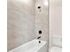 Contemporary bathroom with a sleek bathtub and tiled shower, designed for relaxation and style at 3022 Peel Ave, Orlando, FL 32806