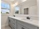 Modern bathroom featuring dual sinks, sleek fixtures, and abundant natural light at 3022 Peel Ave, Orlando, FL 32806