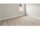 Bright bedroom with a window offering natural light and plush carpeting for added comfort at 3022 Peel Ave, Orlando, FL 32806