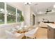 Bright dining area with a glass table, comfortable chairs, and large windows offering a view of the backyard at 3022 Peel Ave, Orlando, FL 32806