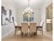 Elegant dining room with a chandelier, stylish decor, and a view into the modern kitchen at 3022 Peel Ave, Orlando, FL 32806