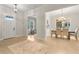 Welcoming foyer with light hardwood floors, a dining area, and a view of a home office through an open doorway at 3022 Peel Ave, Orlando, FL 32806