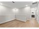 Hallway with wood floors leading to other rooms, including a bathroom at 3022 Peel Ave, Orlando, FL 32806
