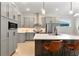 Modern kitchen boasting gray cabinets, stainless steel appliances, an island with seating, and stylish pendant lighting at 3022 Peel Ave, Orlando, FL 32806