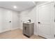 Functional laundry room offers a sink, storage cabinet, and ample space for laundry appliances at 3022 Peel Ave, Orlando, FL 32806