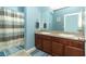Bathroom featuring a double sink vanity with a tub and shower with striped curtain at 319 Morning View Dr, Winter Garden, FL 34787