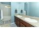 Well-lit bathroom featuring a double sink vanity with stone counters, and tub with shower at 319 Morning View Dr, Winter Garden, FL 34787