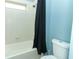 Clean bathroom featuring a white tiled shower, tub, and toilet with blue walls at 319 Morning View Dr, Winter Garden, FL 34787