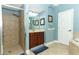 Well-lit bathroom with a glass shower, vanity with a tan countertop, and blue walls at 319 Morning View Dr, Winter Garden, FL 34787