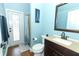 Well-lit bathroom features an exterior door, updated vanity, and shower with stylish curtain at 319 Morning View Dr, Winter Garden, FL 34787