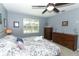 Comfortable bedroom with neutral walls, two dressers, ceiling fan, and a bright window at 319 Morning View Dr, Winter Garden, FL 34787