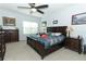 Carpeted main bedroom features a large window, ceiling fan and classic decor at 319 Morning View Dr, Winter Garden, FL 34787
