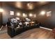 Media room with several theatre-style leather reclining chairs and dark finishes at 319 Morning View Dr, Winter Garden, FL 34787