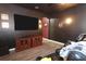 Media room has dark paint, a large television, and wood look floors at 319 Morning View Dr, Winter Garden, FL 34787