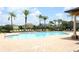 Resort-style community pool with lounge chairs, palm trees, and meticulously maintained brick pavers at 319 Morning View Dr, Winter Garden, FL 34787