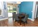 Cozy dining area featuring a wooden table, gray upholstered chairs, and sliding glass doors to the pool at 319 Morning View Dr, Winter Garden, FL 34787