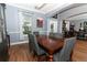 Open-concept dining room with hardwood floors, a wooden dining table, and gray chairs at 319 Morning View Dr, Winter Garden, FL 34787