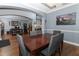 The dining area features an elegant chandelier, a table with chairs, and wood floors at 319 Morning View Dr, Winter Garden, FL 34787