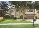 Charming two-story home with a well-manicured lawn, mature trees, and a two-car garage at 319 Morning View Dr, Winter Garden, FL 34787