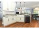 Bright kitchen with white cabinets, granite countertops, a farmhouse sink, and a modern faucet at 319 Morning View Dr, Winter Garden, FL 34787
