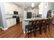 Modern kitchen with white cabinets, granite countertops, stainless steel appliances, and a breakfast bar at 319 Morning View Dr, Winter Garden, FL 34787