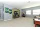 Expansive living room offers plenty of natural light and neutral carpet at 319 Morning View Dr, Winter Garden, FL 34787