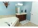 Main bathroom featuring corner tub, vanity with double sinks, and tiled floor at 319 Morning View Dr, Winter Garden, FL 34787