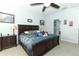 Comfortable main bedroom showcasing a dark wood bed frame, side table and calming blue wall paint at 319 Morning View Dr, Winter Garden, FL 34787