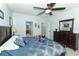 Bright main bedroom featuring a ceiling fan, a comfortable bed, and private bathroom entrance at 319 Morning View Dr, Winter Garden, FL 34787