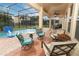 Screened-in patio features comfortable seating, ceiling fan, and overlooks a private pool and manicured landscaping at 319 Morning View Dr, Winter Garden, FL 34787