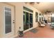 Covered patio features a ceiling fan, furniture and sliding door to interior of home at 319 Morning View Dr, Winter Garden, FL 34787