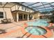 Private pool and hot tub with a screened enclosure and expansive patio deck offer a space for entertaining at 319 Morning View Dr, Winter Garden, FL 34787