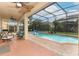 Enclosed pool with hot tub, fountains, and backyard views, accessible from covered patio with ceiling fans at 319 Morning View Dr, Winter Garden, FL 34787