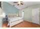 Bright bedroom featuring a ceiling fan, a cozy bed, and stylish decor at 3342 Sanborn Ln, Deltona, FL 32738