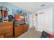 Spacious bedroom boasts light blue walls, a TV, and closet with basketball hoop at 3342 Sanborn Ln, Deltona, FL 32738