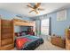 Unique bedroom features a wooden loft bed with gaming decor and a ceiling fan at 3342 Sanborn Ln, Deltona, FL 32738