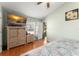 Bedroom with wood floors, ceiling fan, and well-lit natural light from window at 3342 Sanborn Ln, Deltona, FL 32738